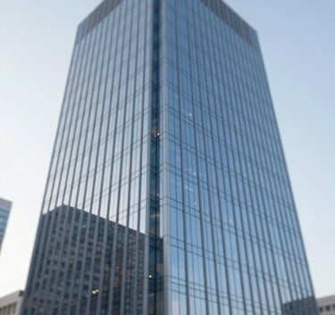 A wide shot of a modern glass skyscraper reflecting a clear sky, clean architectural lines, professional atmosphere, incorporating palette colors #A0AEC0 and #4A5568.