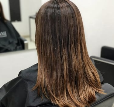 A South American / Brazilian woman with long, silky, shiny hair looking over her shoulder, soft warm lighting, professional photography.