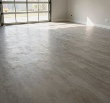 A wide shot of a perfectly clean and swept garage floor in a North American home after all junk has been removed. Soft morning light coming through the garage door, high-contrast, clean lines.