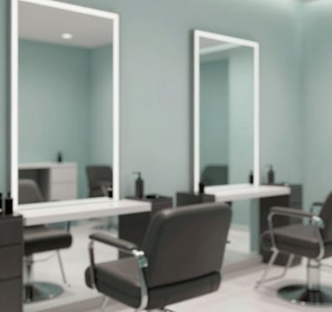A sophisticated, high-end hair salon interior with modern chairs and large mirrors. The atmosphere is tranquil and professional, with a color palette dominated by soft teals and mist grays (#607D7D, #F5F9F8).