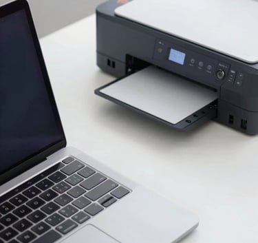 A top-down view of a workstation featuring a laptop and a modern inkjet printer, emphasizing a clean, wireless connection. Professional workspace vibe with #1B263B accents.