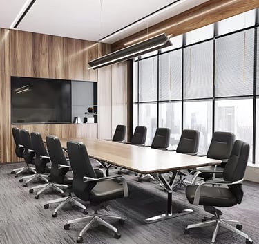 Modern conference room with a large wooden table, black leather office chairs, and wood wall panels.