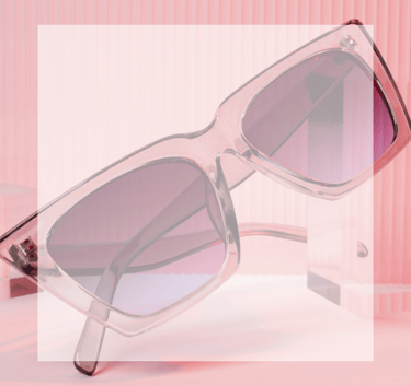 Sunglasses -a pair of pink square sunglasses with a pink background