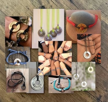 Image of hands with stamped personal bracelet pendants