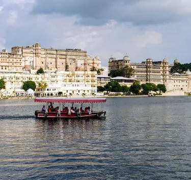 Boat ride on Lake Pichhola with City Palace Udaipur in the background.