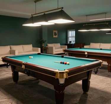 A wide, clean shot of an upscale billiards room in Alpharetta. The room features dark slate green walls, soft cream furniture, and professional lighting focused on several well-maintained pool tables.