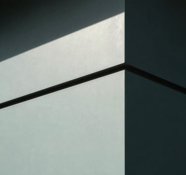 A minimalist, high-end close-up of architectural details, focusing on the interplay of light and shadow on a smooth facade. The color palette includes dark charcoal and pale celadon, reflecting a mood of modern professionalism.
