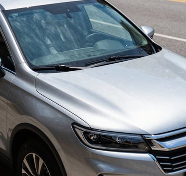 A side view of a modern SUV parked on a clean North American street, focusing on the pristine, newly replaced windshield reflecting a clear blue sky, sharp and crisp photography.