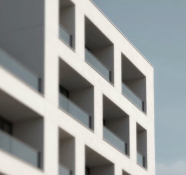 A stylized architectural detail of a modern white building facade against a clear sky, featuring sharp lines and shadows, incorporating the professional palette with hints of #5A6B6D and #2A363B.