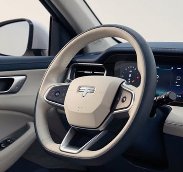 Interior of a modern vehicle showing a clean leather steering wheel and a digital dashboard, shot with professional lighting in tones of steel blue and soft off-white.