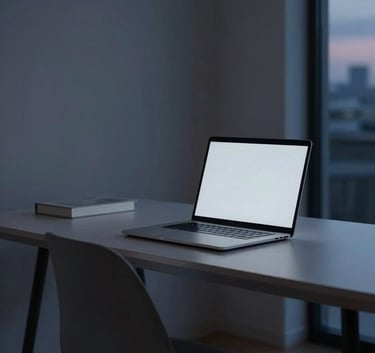 A wide photography shot of a sleek, minimalist home office in the US at twilight. A laptop screen glows softly in light grey and navy blue tones. The atmosphere is quiet, secure, and professional.