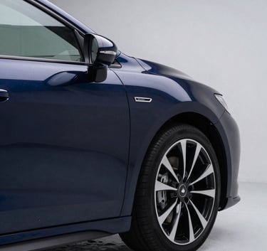 A sleek, dark luxury car being detailed in a professional studio in Calgary, lighting is dramatic with reflections of Steel Blue and Powder Blue, high-end North American / Canadian automotive aesthetic.