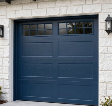 A close-up photograph of a brand new, modern dark blue garage door with vertical frosted glass windows, set against a clean off white stone exterior of a North American home.