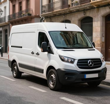 Photography of a clean white removal van with steel blue accents parked on a sunny street in Santander, Spain. Professional and efficient mood, European / Spanish city background.