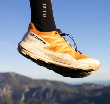 a person's feet in the air with a pair of socks on