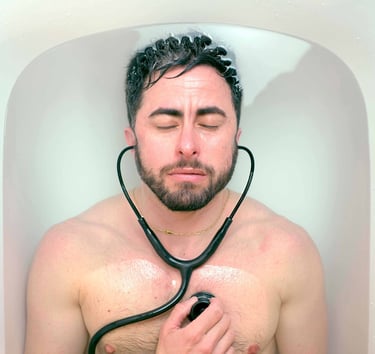 Bearded man in a white bathtub using a stethoscope to listen to his own heart for wellness monitoring.