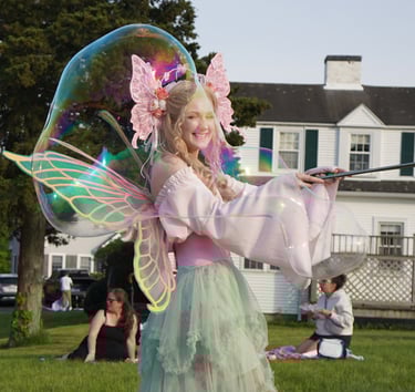 Bubble fairy making bubbles for guests