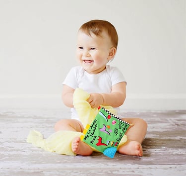 Baby holding My 1st Arabic Number Book by Desi Doll