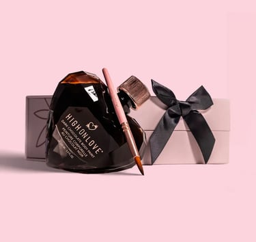 The photo shows a HighOnLove product  - a chocolate body paint, packaged in a crystal glass heart. 