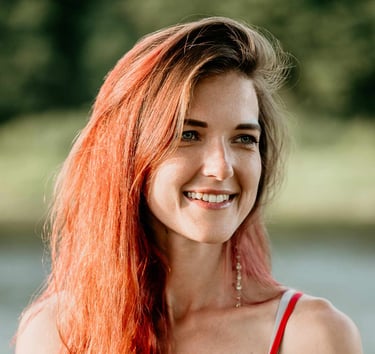 a woman with red hair and a red dress