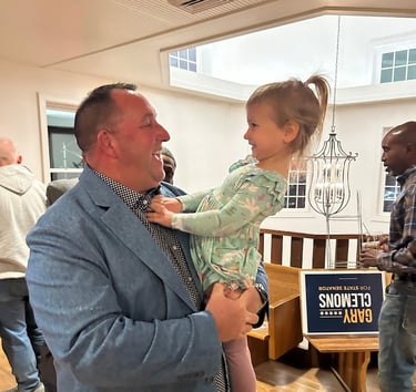 a man in a suit and tie is holding a baby