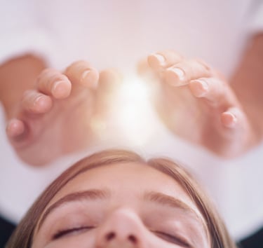 Hands projecting light hovering above a head