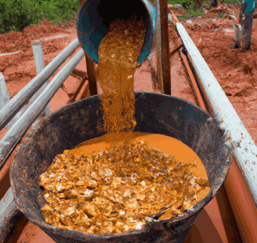 a bucket of food is being poured into a bucket