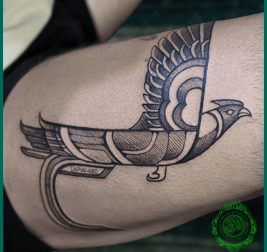 Linework tattoo of a custom bird on the thigh