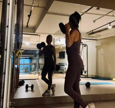 a woman in a gym suit is doing a boxing exercise