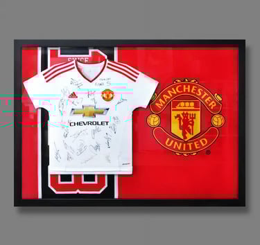 A jersey frame featuring team-signed Manchester United Jersey set against their team flag.