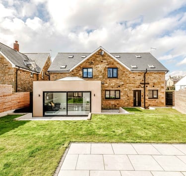 a house with a large garden area with a patio and a patio