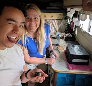 Small rescued bird in camper hand during Poland road trip