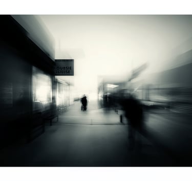 a blurry photo of people walking on a sidewalk