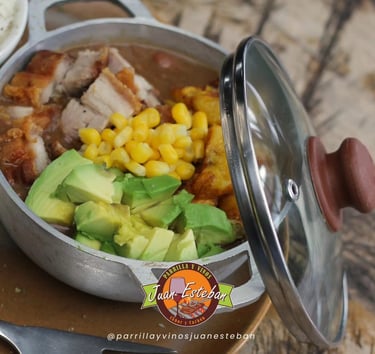 Plato típico colombiano servido en olla metálica en Parrilla y Vinos Juan Esteban, con cerdo asado, 
