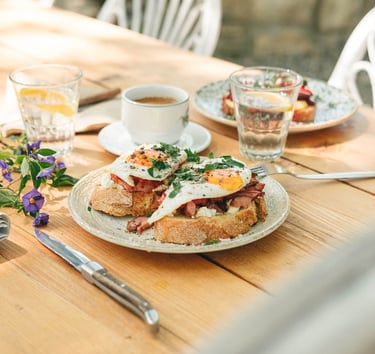 a table with a plate of greek mezze and a cup of coffee