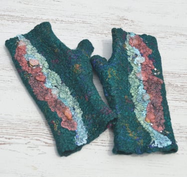Handmade emerald green felted wool fingerless gloves with colorful textured fiber art details.
