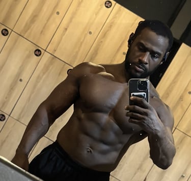 Black guy with muscular physique wearing black shorts taking photo r