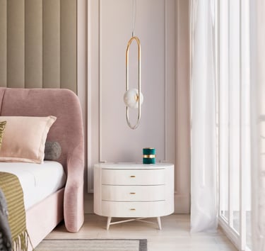 Modern luxury bedroom featuring a white nightstand, pink upholstered bed, and gold oval pendant light.