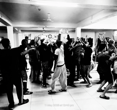 Group dance and movement therapy session with residents celebrating together in the activity hall.