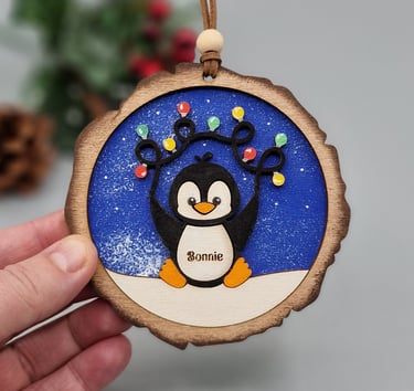personalised penguin bauble with christmas lights
