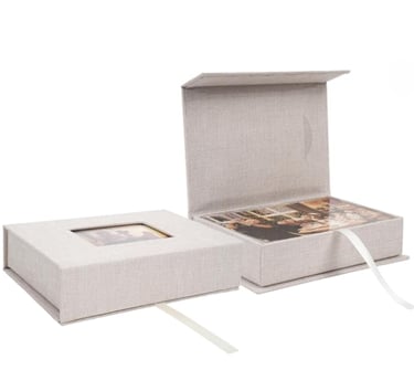 Handmade linen photo storage boxes with magnetic lids and ribbon pull for organizing family memories.