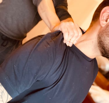 a man receiving a shoulder massage