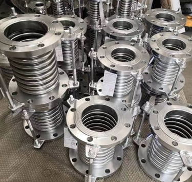a bunch of metal pipe flanged flanges and a lot of metal