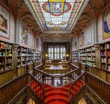 a staircase way with a red carpet and a skylight