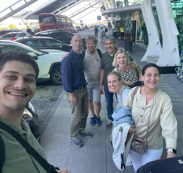 a group of people standing around a luggage carton
