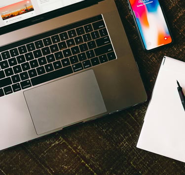 a laptop and a notebook on a table.Revenue Management for Hotels with Timea Pokol Consultant