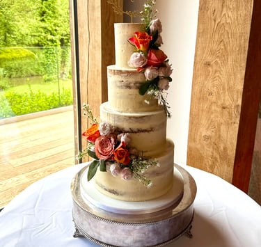 Semi Naked 4 tier Wedding cake with Fresh Flowers by Sweetcupcakes cakery