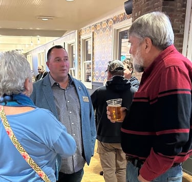 a group of people standing around a table
