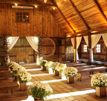 a barn decorated in off whites for a wedding