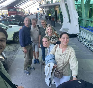 a group of people standing around a luggage carton